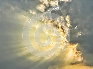 Dramatic dark and golden storm clouds with sunbeams