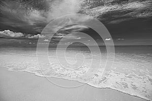 Dramatic dark minimal beach landscape. Sea sand sky, monochrome black and white shore coast view