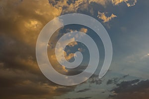 Dramatic darkclouds under blue sky with sunbeam