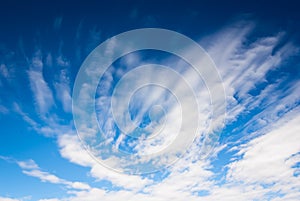 Dramatic deep blue sky with streaky clouds
