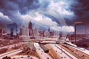 Dramatic drone photo of storm clouds over Atlanta skyline and highway during the day