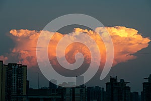 Dramatic evening sky and clouds at sunset over city