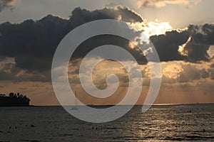 Dramatic evening sunset cloudy sky at the Surin Beach Phuket Thailand.