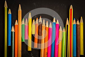 Dramatic group of pencils on black or dark background.