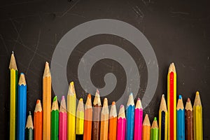 Dramatic group of pencils on black or dark background.