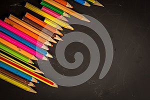 Dramatic group of pencils on black or dark background.