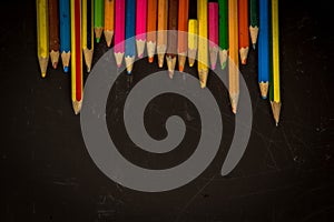 Dramatic group of pencils on black or dark background.