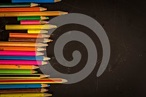 Dramatic group of pencils on black or dark background.