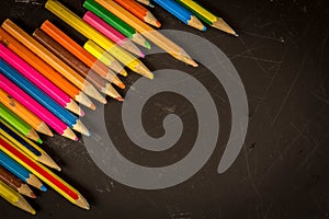 Dramatic group of pencils on black or dark background.