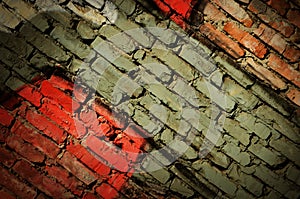 Dramatic grunge painted old wall with diagonal bricks, creative background for your design