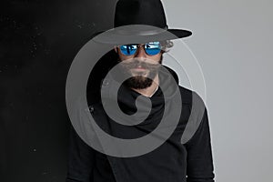 Dramatic gypsy man with black hat and sunglasses posing