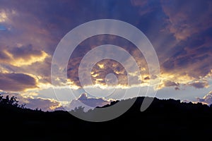 Dramatic heavenly cloudscape at sunset and silhouette of hillrange