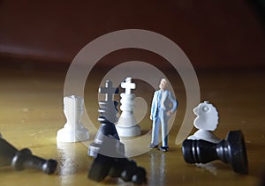 dramatic illustration for photo War or politic situation concept, 1 standing mini figure, help the king chess to win