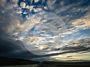 Dramatic image of Panoramic view with A long curve road in the early morning against sunrise sky,cloudy and foggy, Slovakia