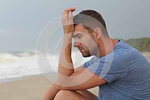 Dramatic image of pensive man at the beach