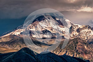 Dramatic landscape view of Mt Kazbeg and Tsminda Sameba church, Caucasus mountains, Country of Georgia