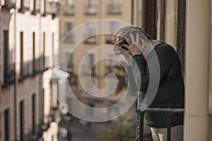 Dramatic lifestyle portrait of mature woman on her 70s crying depressed and sad at home balcony feeling desperate suffering