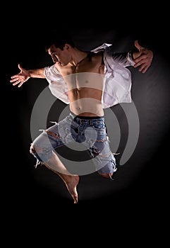 Dramatic light photo of modern acrobat jumping