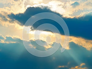 Dramatic light rays coming out of clouds background
