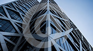 Abstract Geometric Facade of a Modern Skyscraper Against a Blue Sky architectural facade