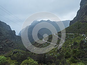 Dramatic lush green landscape with winding curvy mountain road towards Masca village situated in a picturesque valley, Tenerife,