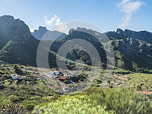 Dramatic lush green picturesque valley with old village Los Carrizales . Landscape with sharp rock formation, hills and