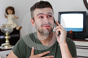 Dramatic man crying on the phone