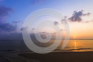 Dramatic and moody multi colors of setting sun and clouds