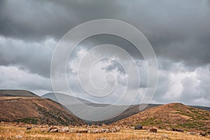 Dramatic mountain valley under a cloudy sky with a rugged landscape