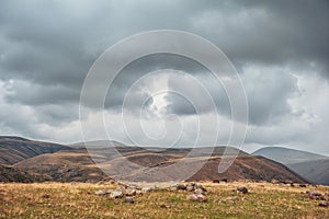 Dramatic mountain valley under a cloudy sky with a rugged landscape