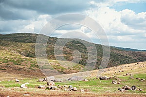 Dramatic mountain valley under a cloudy sky with a rugged landscape