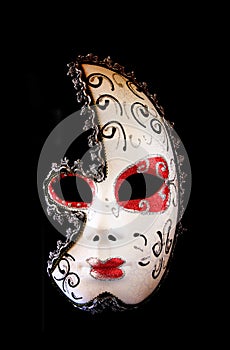 Dramatic and mysterious half moon carnival mask isolated on black