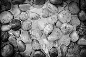 Dramatic nature pattern, pebbles in shallow water