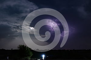 Dramatic night cloudscape with thunderbolt lightning and moon light