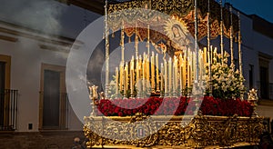 Holy Week float with statue and glowing candles