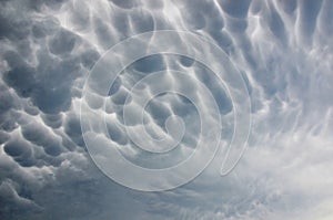 Dramatic ominous mammatus clouds during thunderstorm