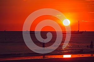 Dramatic orange sea sunset with boats. Summer time. Travel to Philippines. Luxury tropical vacation. Boracay paradise island.