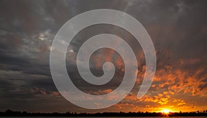 dramatic orange sky with black clouds At dusk, the weather is inclement. cover design template for book, magazine, website photo