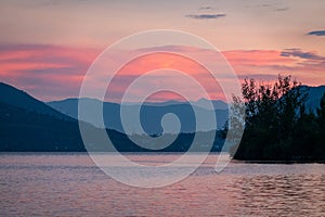 Dramatic panorama evening sky and clouds over mountain and lake at sunset