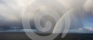 Dramatic Panoramic View of a cloudscape with Rainbow