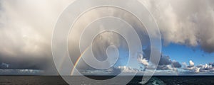 Dramatic Panoramic View of a cloudscape with Rainbow