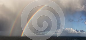 Dramatic Panoramic View of a cloudscape with Rainbow