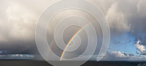 Dramatic Panoramic View of a cloudscape with Rainbow