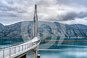 Dramatic photo of Helgelandsbrua norwegian or Helgeland Bridge is Norway`s finest bridges between Alstahaug and Leirfjord at photo