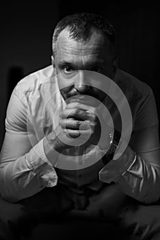 Dramatic portrait of an adult man. Studio photography. Black and white image