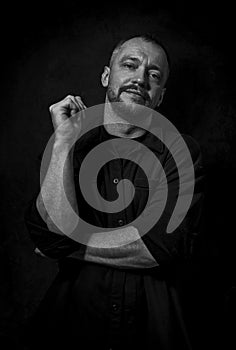 Dramatic portrait of an adult man. Studio photography. Black and white image
