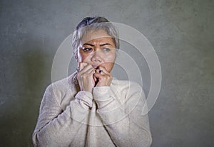 Dramatic portrait of attractive sad and depressed middle aged Asian woman crying helpless suffering depression problem and anxiety