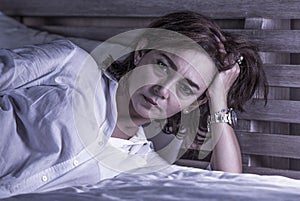 Dramatic portrait of attractive sad and depressed middle aged woman upset and lonely on bed suffering depression thoughtful and