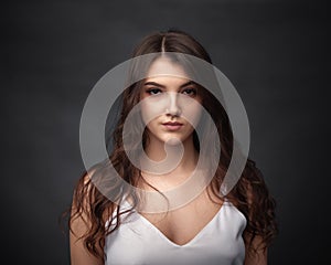 Dramatic portrait of a beautiful girl on a dark background