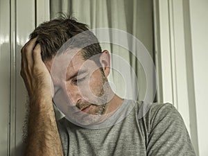 Dramatic portrait of middle aged sad and depressed man in pain feeling stressed and frustrated suffering depression problem and